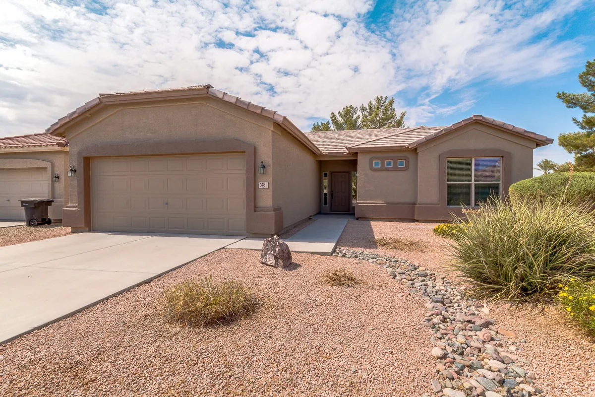 This exterior image showcases the front entrance of a single-family home, complete with a garage door, manicured landscaping, and a welcoming pathway. The porch invites outdoor relaxation and gatherings, embodying the community's friendly spirit.
